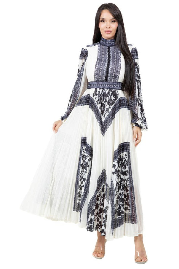 Woman wearing a white dress with black and blue pattern on a white background